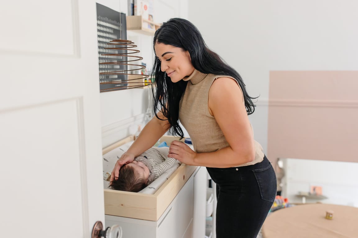 Ashlee gently attending to a newborn baby