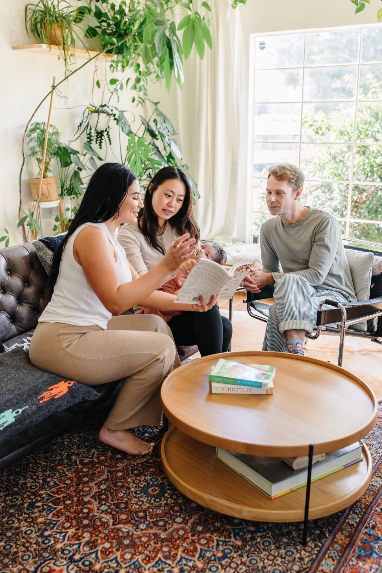 Ashlee walking parents through a fourth-trimester book together on the couch