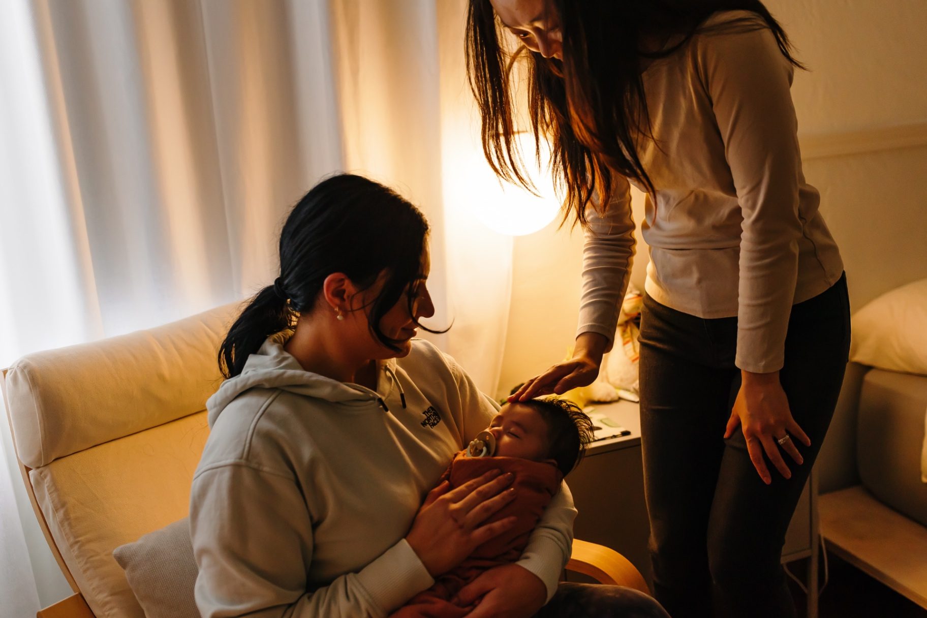 Ashlee offering a reassuring hand to a parent rocking their baby late at night